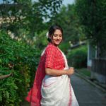 white check khadi with red white weaving with white show button blouse