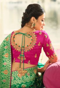 magenta embroidered blouse with green banarashi saree