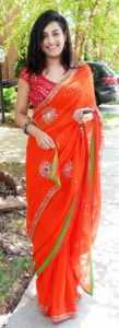 orange mirror work blouse design with flower saree